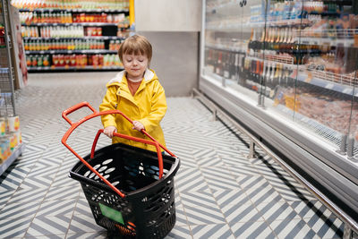 Portrait of boy standing in supermarket