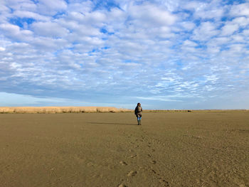 Rear view of woman walking on land