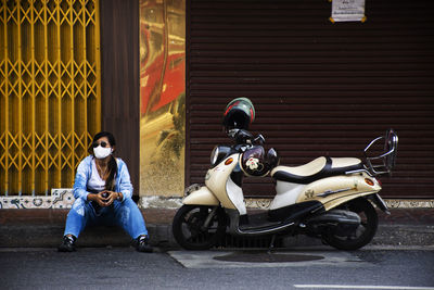 Man sitting on motor scooter