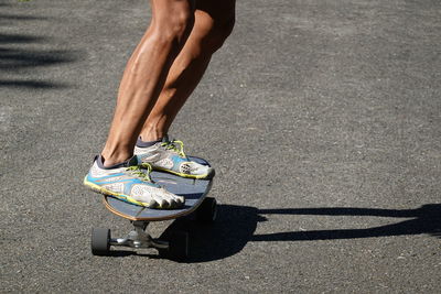 Low section of person wearing shoes on street