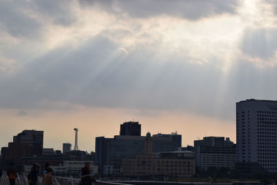 Skyscrapers in city at sunset