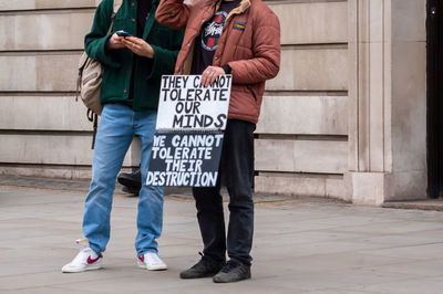 Low section of people walking in city