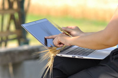 Midsection of person using mobile phone