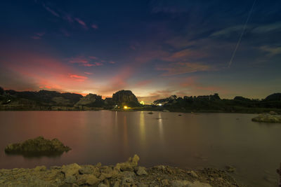 Scenic view of lake against sky during sunset