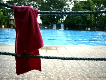 Towel drying on rope against swimming pool