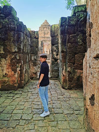 Full length of man standing on wall