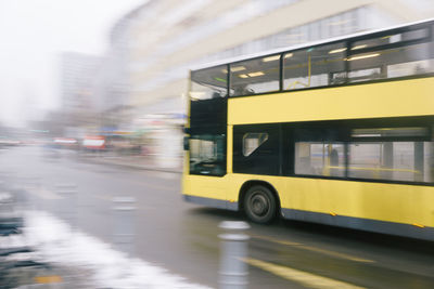 Blurred motion of yellow car in city