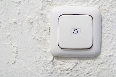 Close-up view of door bell on wall