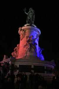 Low angle view of statue against built structure