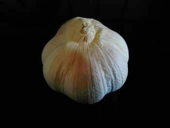 Close-up of garlic over black background