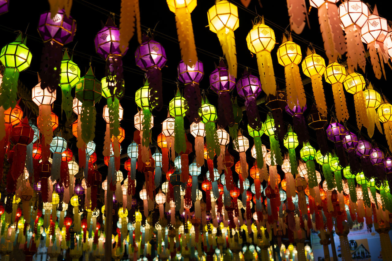 LOW ANGLE VIEW OF ILLUMINATED LANTERNS HANGING IN MARKET