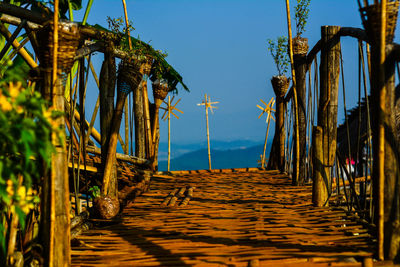 Walkway amidst sea against sky