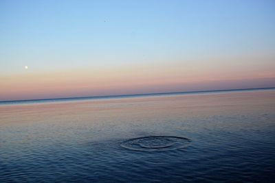 Scenic view of sea against sky at sunset