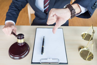 Close-up of man using mobile phone on table