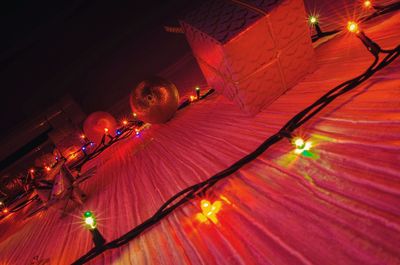 Low angle view of illuminated lamp in city at night