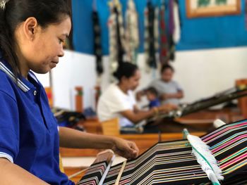 Women weaving in workshop