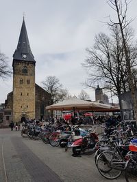 Bicycles against sky in city