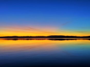 Scenic view of lake against romantic sky at sunset