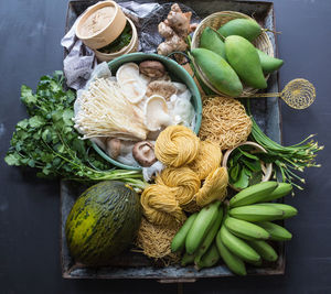 High angle view of vegetables and dry noodles on table