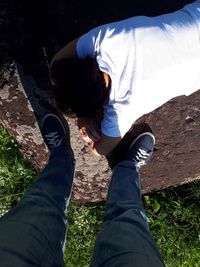 Low section of man wearing shoes on land