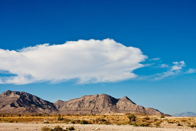 Scenic view of rocky mountains against blue sky