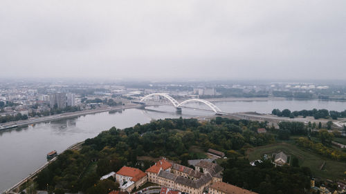 High angle view of river amidst buildings in city against sky