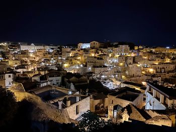 High angle view of illuminated buildings in city at night