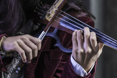 Midsection of woman playing violin