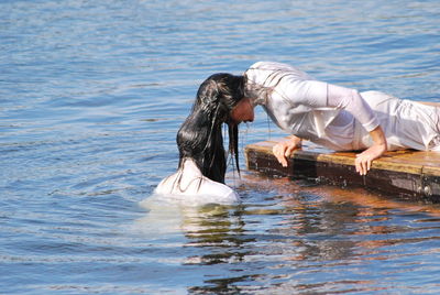 Wet women in lake on sunny day