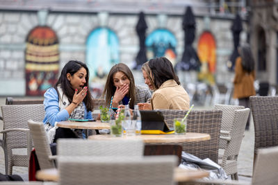 Group of people sitting on table