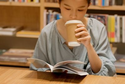 Midsection of boy sitting on table