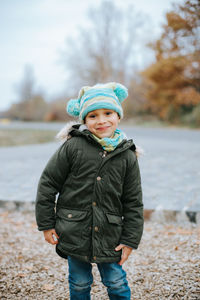 Cute boy standing on land during winter in park