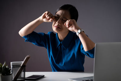 Close-up of young businesswoman crying at office