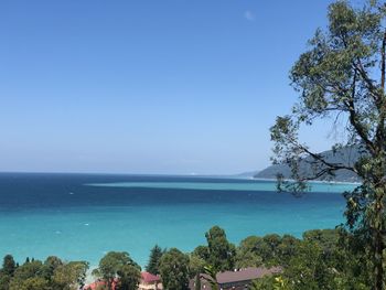 Scenic view of sea against clear blue sky