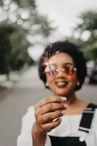 Close-up of woman hand holding dandelion