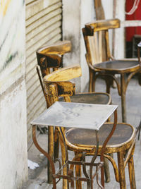 Empty table and chairs at sidewalk cafe