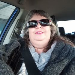 Portrait of woman sitting in car