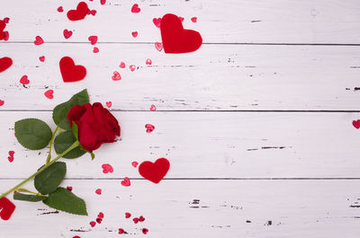 Close-up of red rose on table