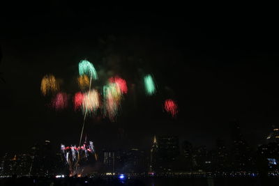 Low angle view of firework display at night