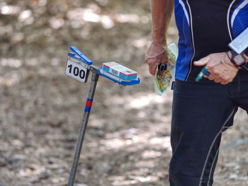 Heavy run in forest. orienteering marker and orange white box outdoor in a forest. popular sport