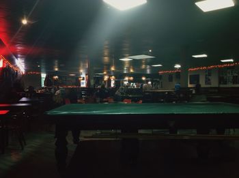 People on illuminated table at night