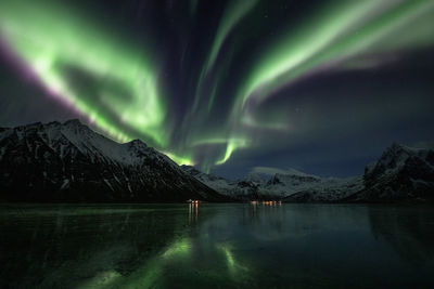 Scenic view of snowcapped mountains against sky at night