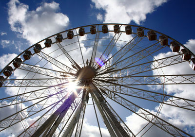 Low angle view of ferris wheel against sky