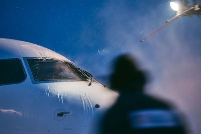 Rear view person standing against airplane and sky