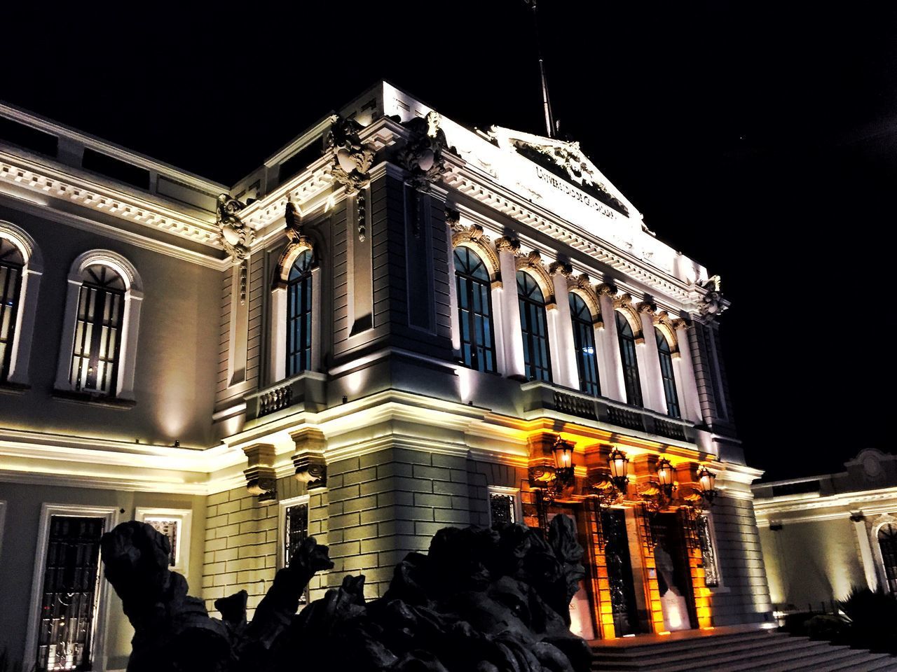 LOW ANGLE VIEW OF ILLUMINATED BUILDING AGAINST SKY