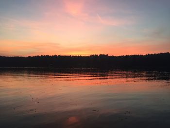 Scenic view of lake against orange sky