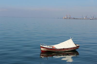 Boat moored on sea against sky