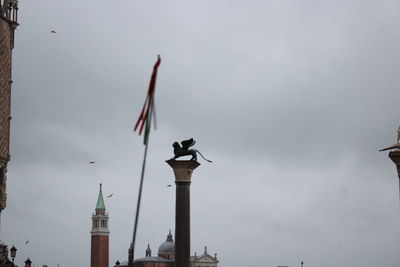 Low angle view of flags against sky