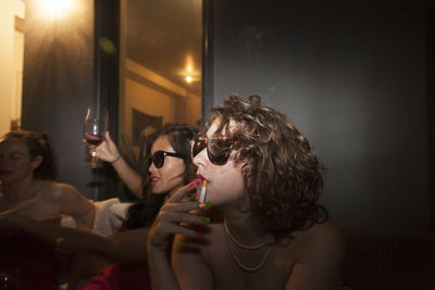 Portrait of a young woman drinking glass