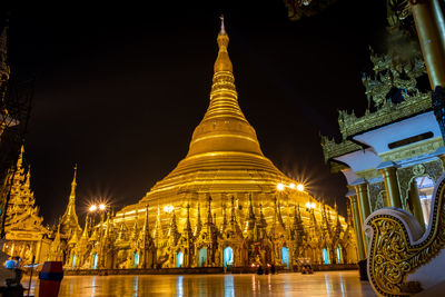 Illuminated temple outside building at night